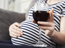 Close Up Of Pregnant Woman Smoking And Drinking